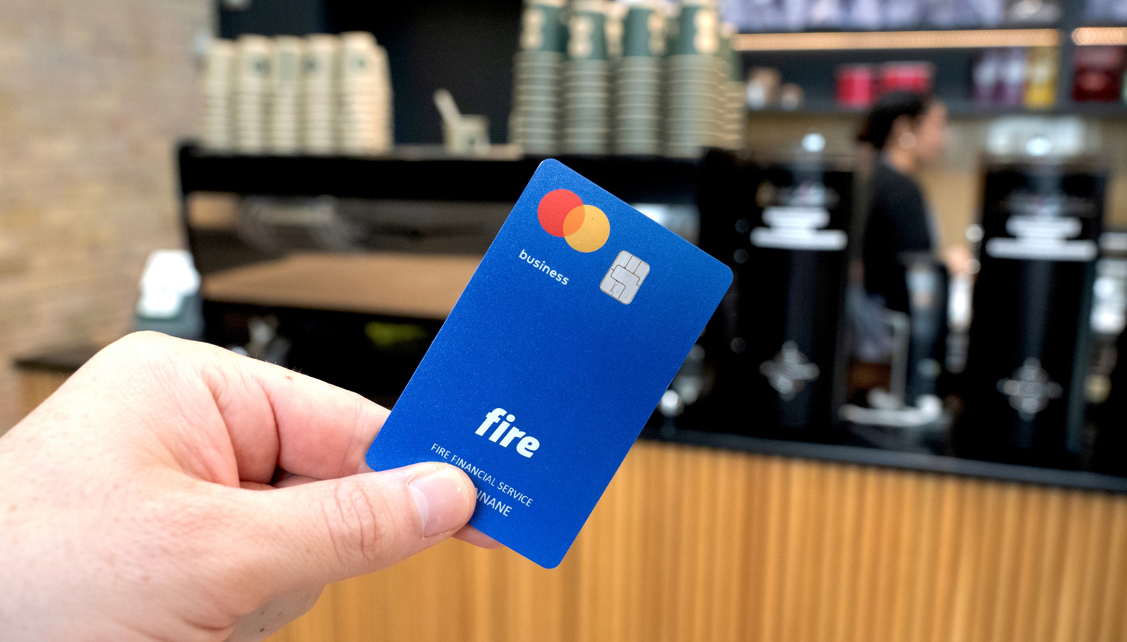 Fire’s business debit card over a coffee shop counter.